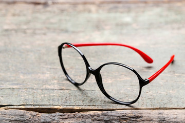 Eye glasses on grey wooden table