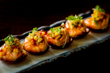 Daily-caught sea shrimp, pan-seared with chilli and topped with warm salsa on a crispy plantain coracle