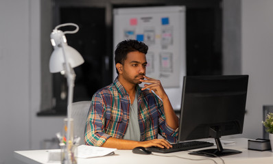 deadline, technology and people concept - creative man with computer working at night office