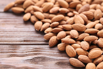 Almonds on brown wooden table