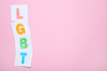 Paper with abbreviation LGBT on pink background