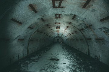 Fototapeta na wymiar Long underground tunnel or corridor in abandoned Soviet military bunker or basement
