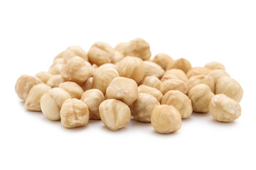 Peeled hazelnuts on isolated white background