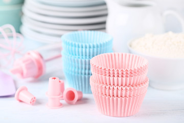 Fototapeta na wymiar Colorful cupcake cases with kitchen utensils