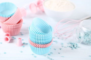 Colorful cupcake cases with sprinkles on white background