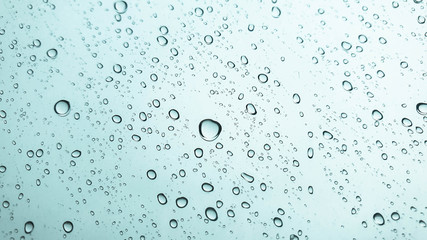 Closeup rain drops on glasses surface-abstract background.