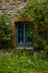 Blue window against stone wall