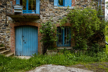 Old french farmhouse with blue windows and door