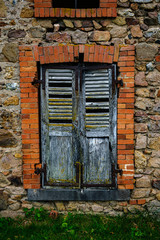 Broken shutters in derelict window
