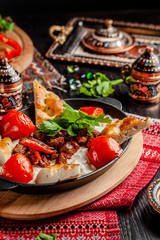 Fototapeta na wymiar Traditional Turkish, Arabic cuisine. Ali Nazik Kebab. Chopped lamb with eggplant, yogurt and garlic. Ottoman food. Serving dishes in the restaurant. copy space