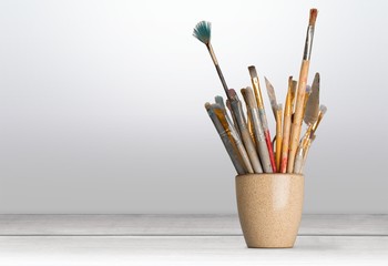 Row of artist paint brushes  on background