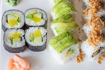 A plate with sushi mix with wasabi