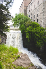 Fototapeta na wymiar Vermillion Falls, an urban waterfall next to an old factory located in Hastings, Minnesota
