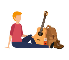 young man with guitar and camping equipment