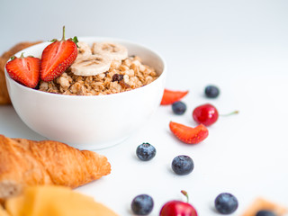 Breakfast berries and oatmeal frame with copy space. Waffle with mango, croissant and cherries