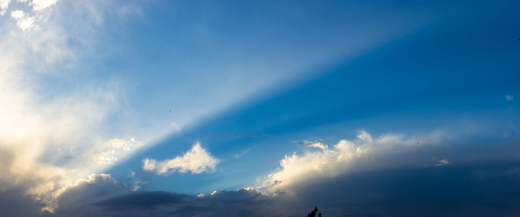 Landscape with dramatic light - beautiful golden sunset with saturated sky and clouds.