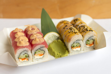 Sushi rolls  in a white eco paper lunch box takeaway. Japanese dish. 