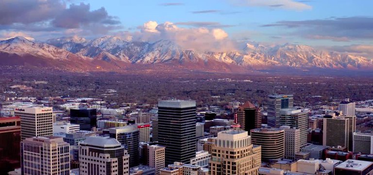 Salt Lake City Utah Skyline At Sunset With Mountains, Aerial Drone