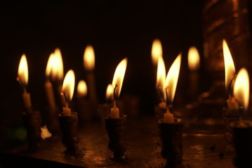 Candlestick with burning candles in church