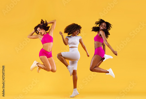 Three Strong And Happy Athletic Women, Jumping Or Dancing On Yellow  Background Wearing Color Sportswear Fitness And Sport Motivation Active  Wall Mural | Acti-Mike Orlov