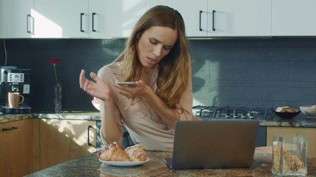 Concentrated woman making photo at mobile phone. Serious woman taking food photo