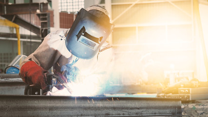 Welding with sparks by Process fluxed cored arc welding in factory , Welding by Welder...