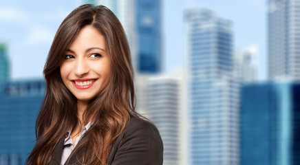 Business, young smiling businesswoman outdoor in a modern city setting