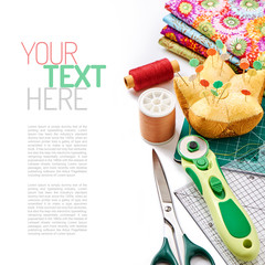 Accessories for quilting on a white surface, top view