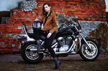 Naklejka na ściany i meble Portrait of beautiful young woman posing with motorcycle