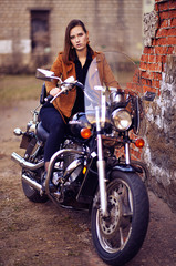 Plakat Portrait of beautiful young woman posing with motorcycle