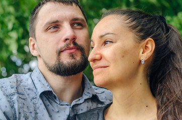 Fototapeta premium Outdoor portrait of a couple in love. Cheerful smiling couple in summer park