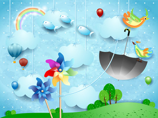Surreal landscape with pinwheels, flying umbrella and fishes