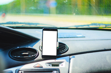 Smartphone on the front of the car as a navigator. Cut out the white background of the screen of the smartphone for placing graphics