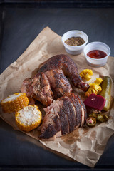 Grilled chicken fillets on paper plate. Iron background