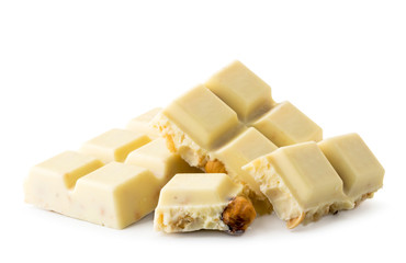 Broken white chocolate bar with nuts on a white. Isolated.