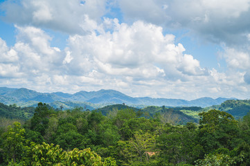 Fototapeta na wymiar Morning green mountains, isolated on a bright sky background, at Narathiwat, Thailand