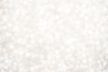 silver Sparkling Lights Festive background with texture. Abstract Christmas twinkled bright bokeh defocused and Falling stars. Winter Card or invitation