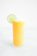 Mango Coconut Cocktail with a Lime Garnish