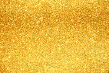 gold Sparkling Lights Festive background with texture. Abstract Christmas twinkled bright bokeh defocused and Falling stars. Winter Card or invitation