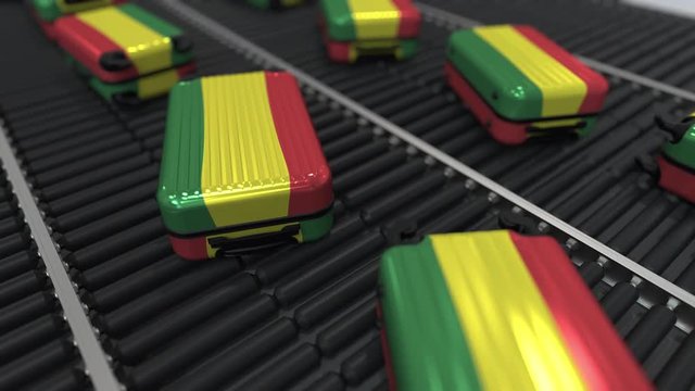Many travel suitcases featuring flag of Bolivia on roller conveyer. Bolivian tourism conceptual animation