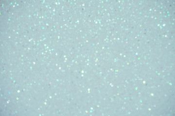 silver Sparkling Lights Festive background with texture. Abstract Christmas twinkled bright bokeh defocused and Falling stars. Winter Card or invitation