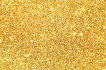 gold Sparkling Lights Festive background with texture. Abstract Christmas twinkled bright bokeh defocused and Falling stars. Winter Card or invitation