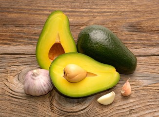  Fresh avocado and garlic on wooden table