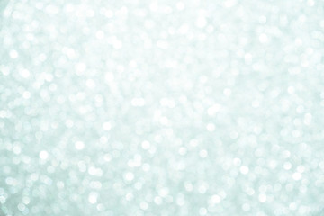 silver Sparkling Lights Festive background with texture. Abstract Christmas twinkled bright bokeh defocused and Falling stars. Winter Card or invitation