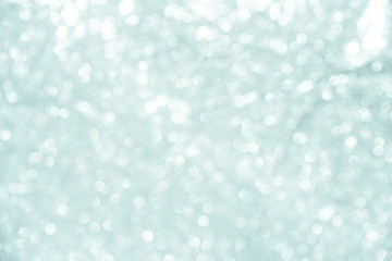 silver Sparkling Lights Festive background with texture. Abstract Christmas twinkled bright bokeh defocused and Falling stars. Winter Card or invitation