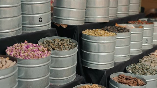 Selection of different arabian spices on a traditional Moroccan market souk in Marrakech, Morocco. A lot of pepper, cardamon, cumin, curry