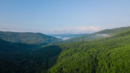 Obraz premium Aerial Landscape View of Caucasus mountain at sunny morning with fog.