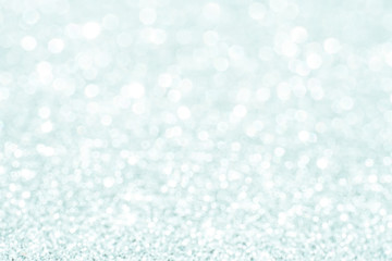 silver Sparkling Lights Festive background with texture. Abstract Christmas twinkled bright bokeh defocused and Falling stars. Winter Card or invitation