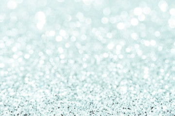 silver Sparkling Lights Festive background with texture. Abstract Christmas twinkled bright bokeh defocused and Falling stars. Winter Card or invitation