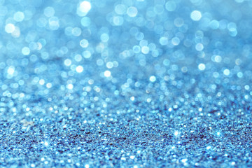 blue Sparkling Lights Festive background with texture. Abstract Christmas twinkled bright bokeh defocused and Falling stars. Winter Card or invitation